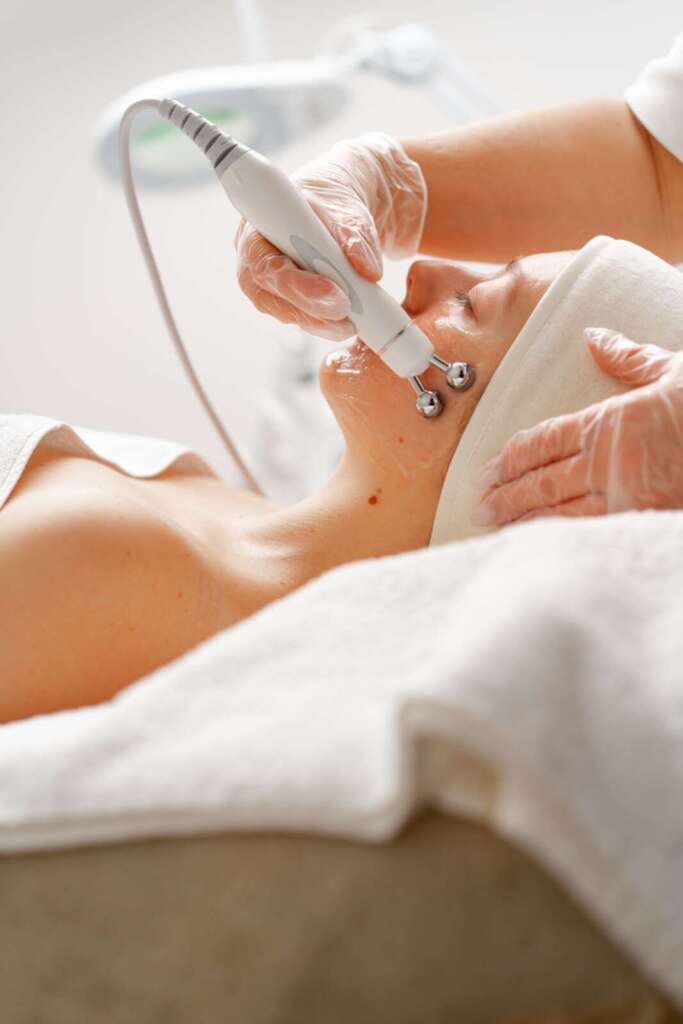 Client relaxing during a facial treatment at Ageless Beauty Laser & Spa